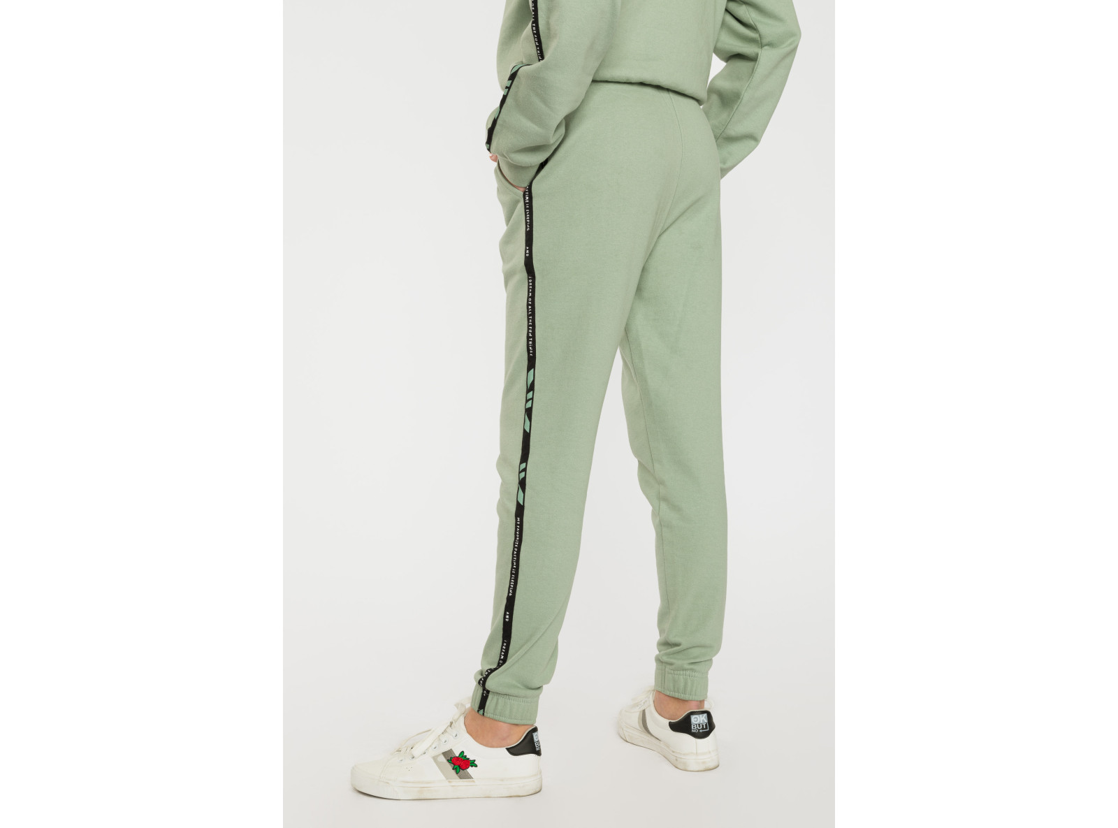 Pistacjowe spodnie dresowe z lampasami