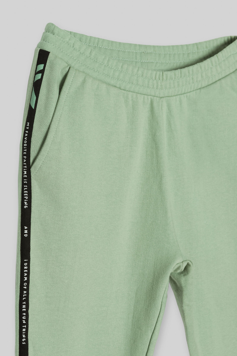 Pistacjowe spodnie dresowe z lampasami