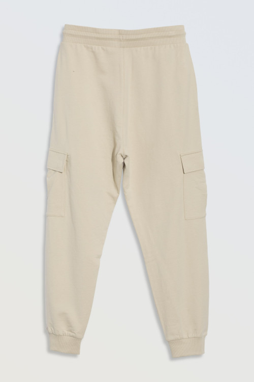 Beżowe spodnie dresowe oversize z przestrzennymi kieszeniami na nogawkach