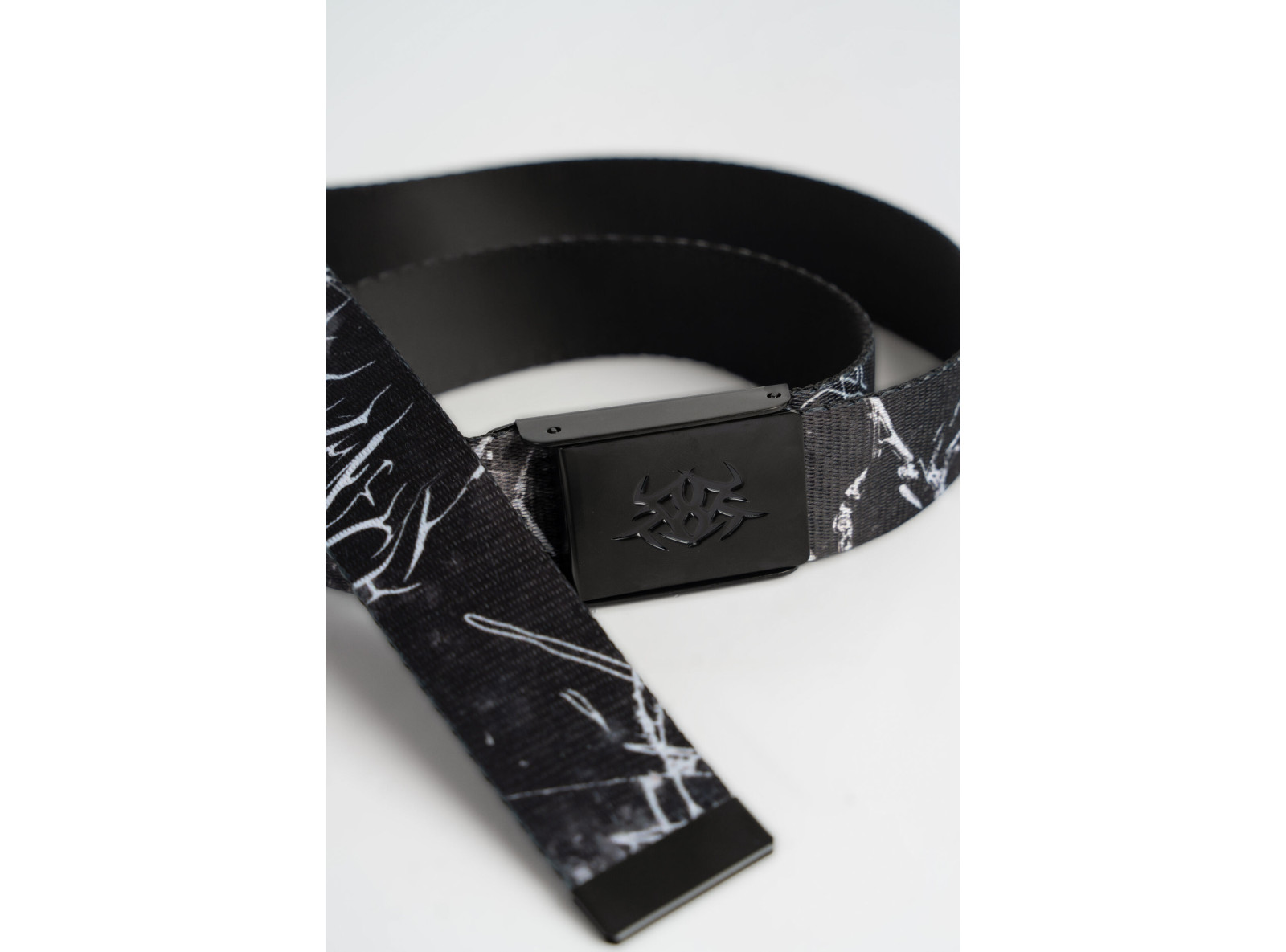 Materiałowy pasek z białym nadrukiem i metalową klamrą