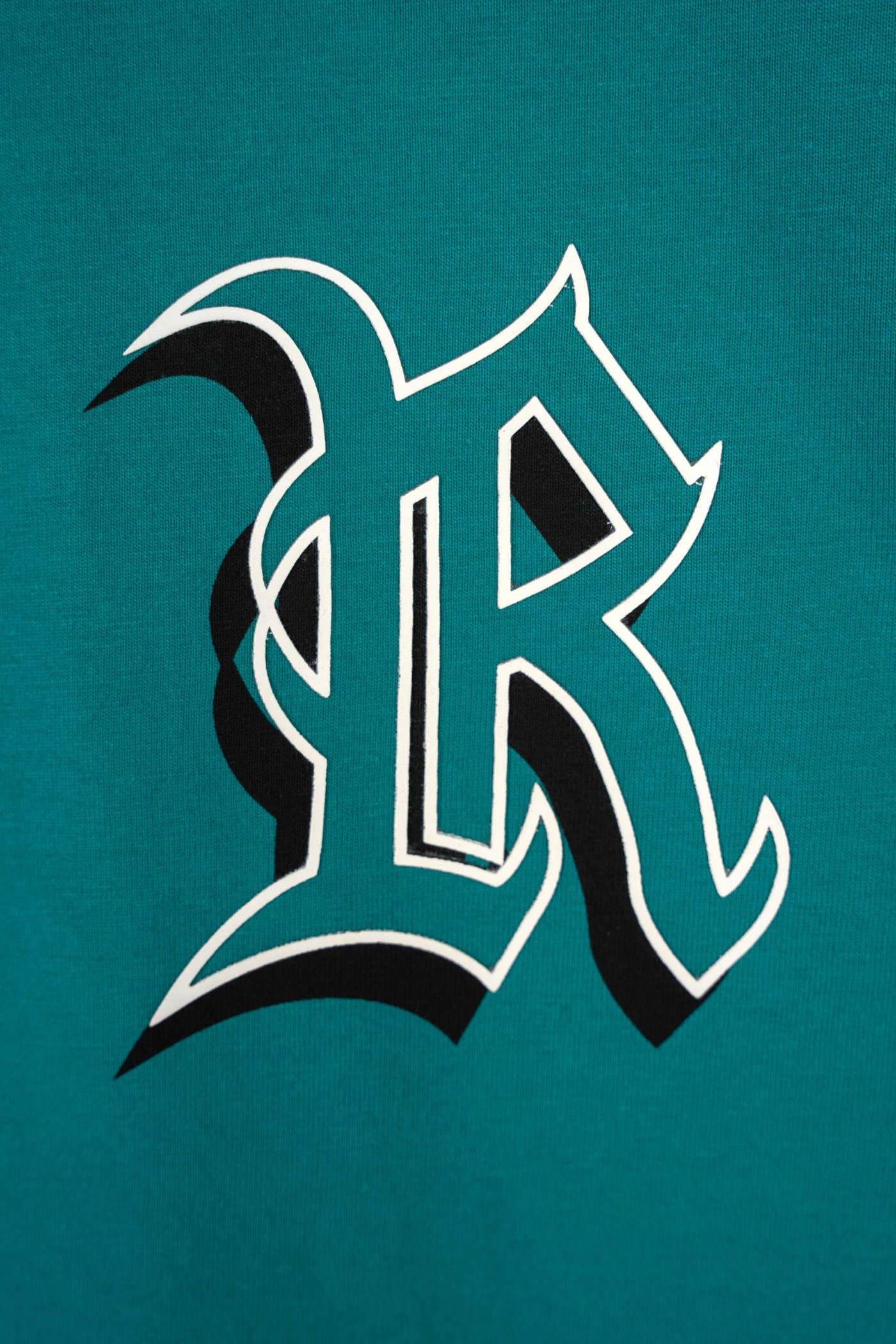 T-shirt w kolorze morskim z grafiką na piersi T-shirt w kolorze morskim z grafiką na piersi