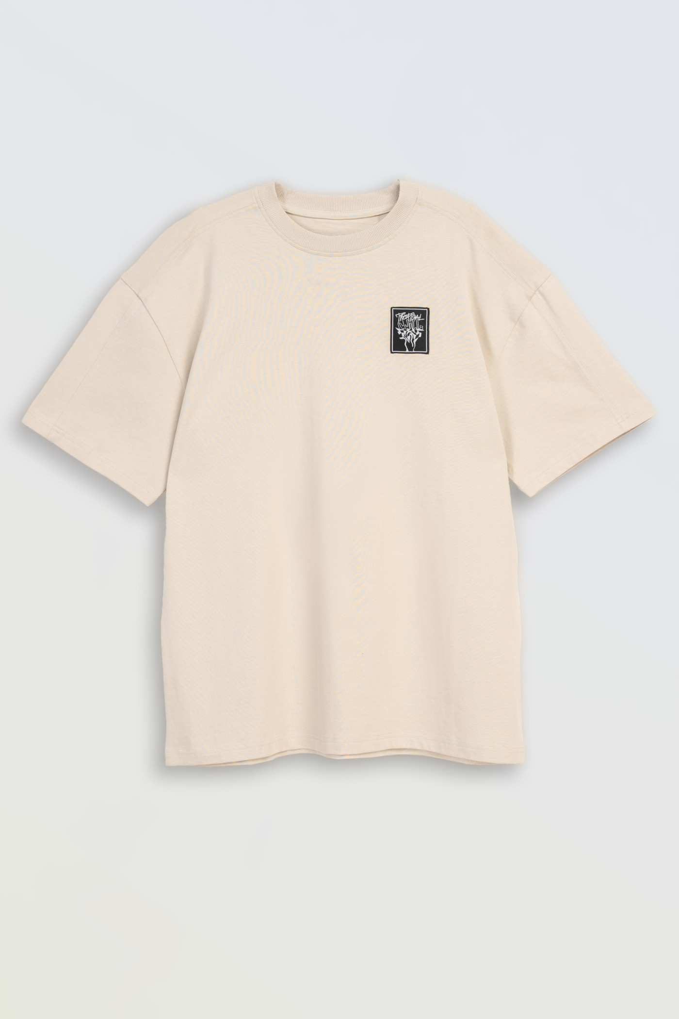 Kremowy t-shirt z autorską grafiką z tyłu Kremowy t-shirt z autorską grafiką z tyłu