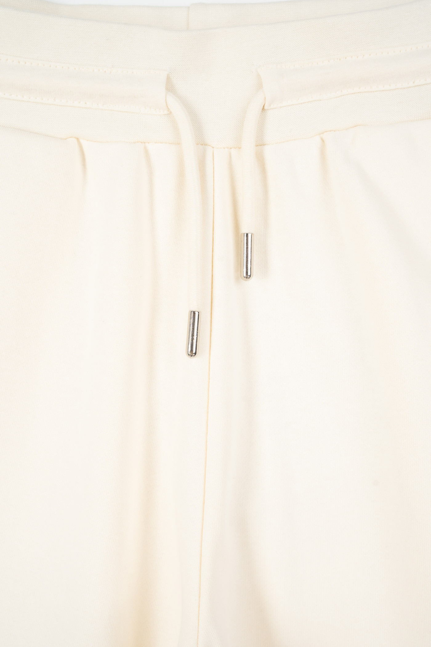 Kremowe spodnie dresowe z szerokimi nogawkami bez nadruków