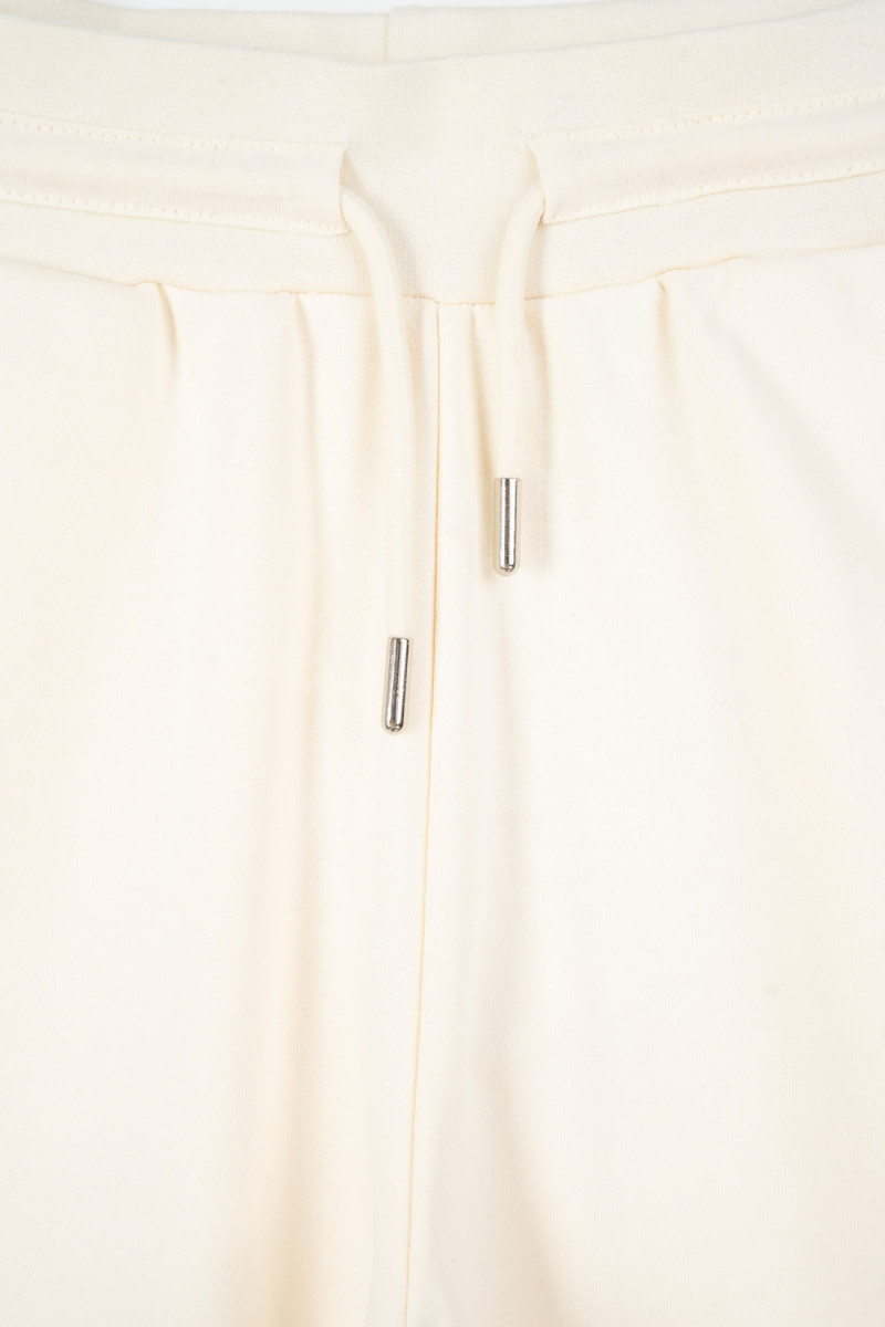 Kremowe spodnie dresowe z szerokimi nogawkami bez nadruków